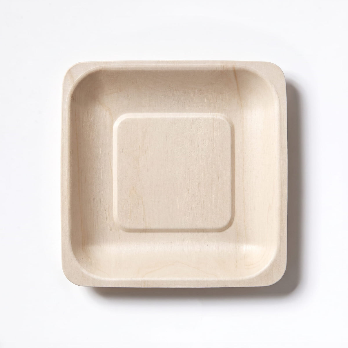 A square light compostable birchwood tray with a raised concentric square design in the center, photographed from directly above on a clean white background.