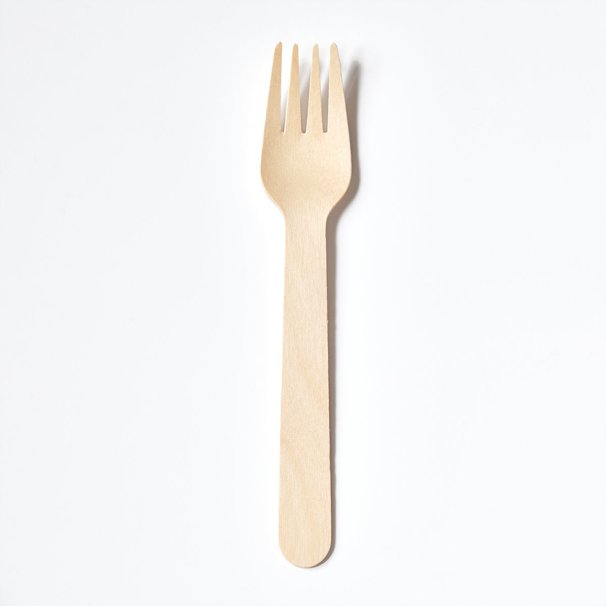 Compostable and disposable wooden fork made from birchwood on a white background