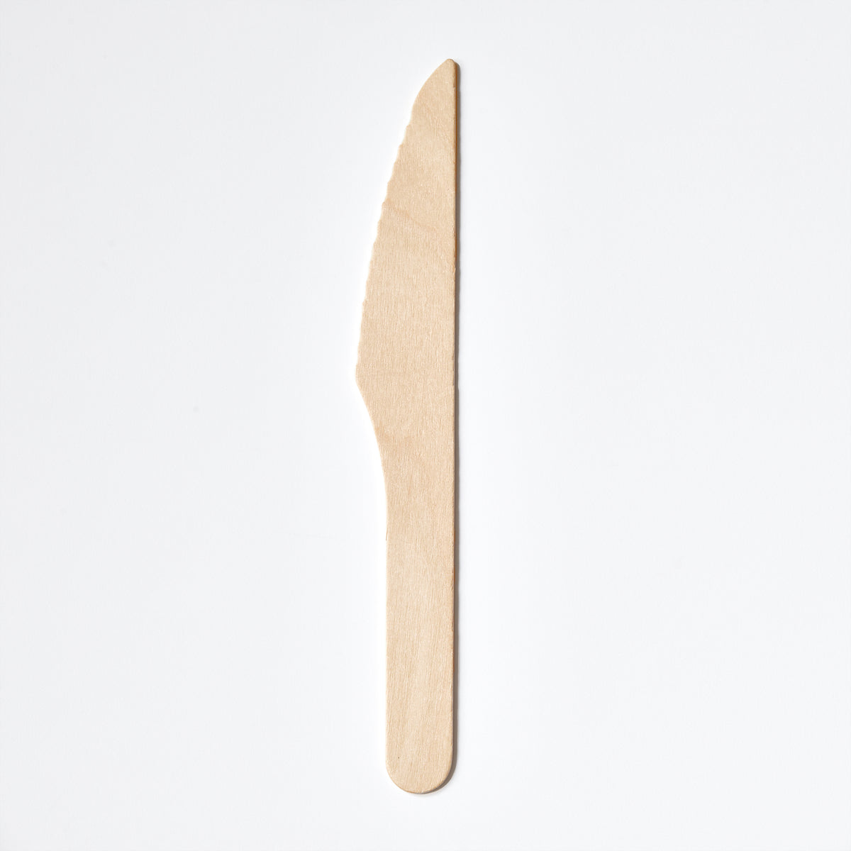A single light natural birchwood disposable wooden utensil, shaped like a knife with a serrated edge, shown vertically on a plain white background.